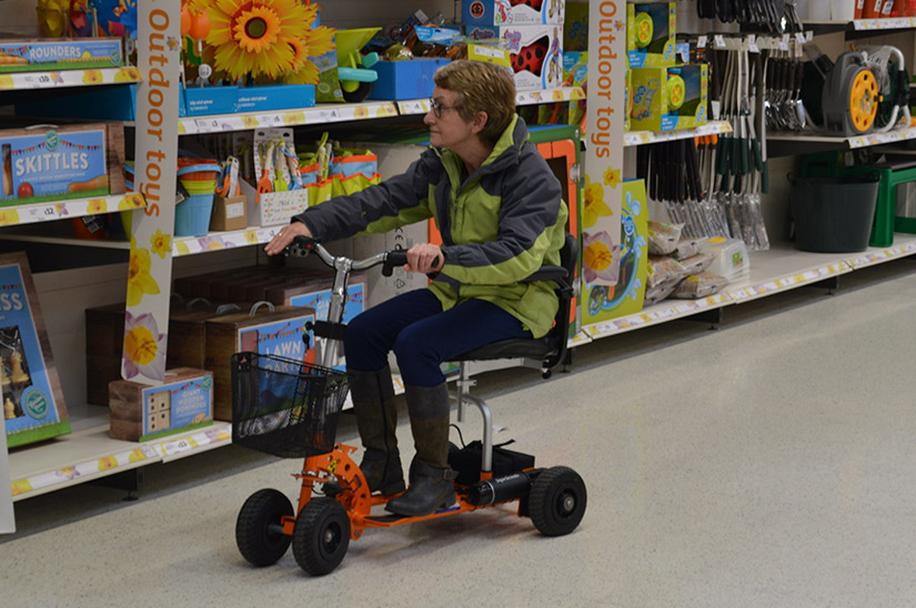 Customer on her SupaScoota in a supermarket