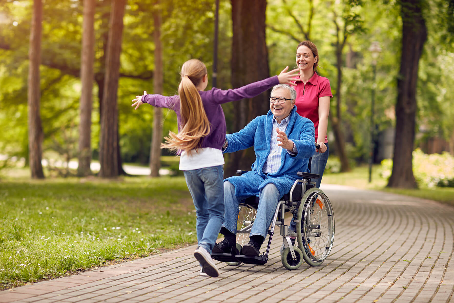 Family reunion with man in wheelchair greeting granddaughter Family reunion with man in wheelchair greeting granddaughter